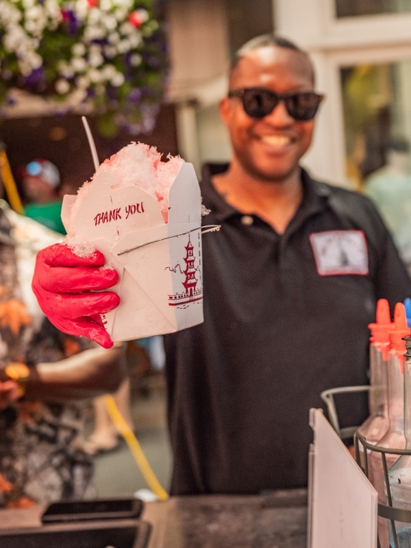Owner/operator Jason “Dunny” Dunigan showing off the signature Snoball delivered in a Chinese “to go” box. 
