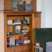 Handmade wool purses on shelving made by wool artisan in Charleston