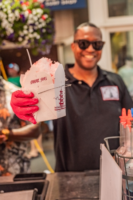 Owner/operator Jason “Dunny” Dunigan showing off the signature Snoball delivered in a Chinese “to go” box. 
